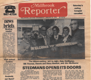 Group of people at a ribbon-cutting ceremony inside a newspaper photo, welcoming Stedmans Opens Its Doors display headline below.