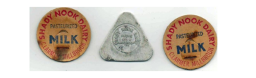 Three dairy bottle caps: two orange round lids reading 'Shady Nook Dairy' and 'Milk' with 'Pasteurized' text, flanking a silver triangular cap in the center.